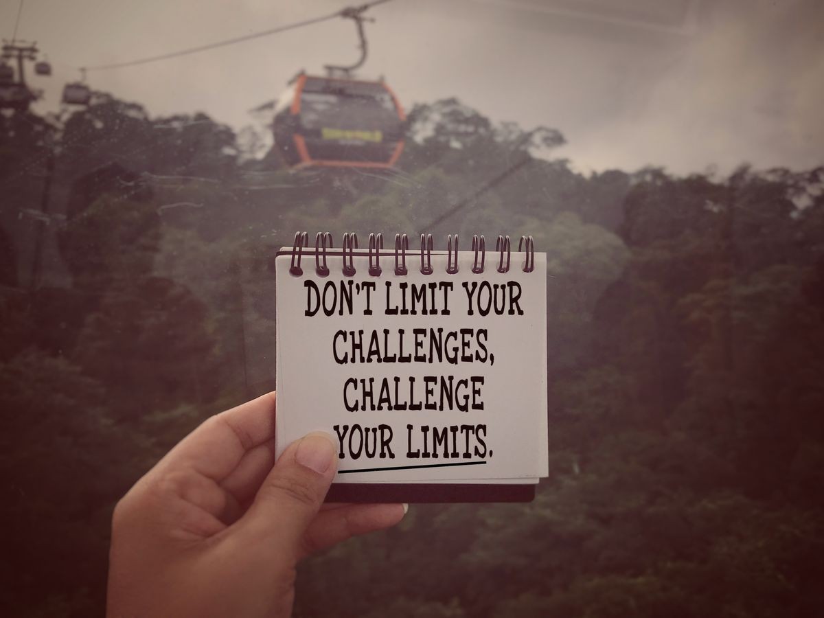 Motivational and inspirational quote - Don’t limit your challenges, challenge your limits. Blurred styled background.